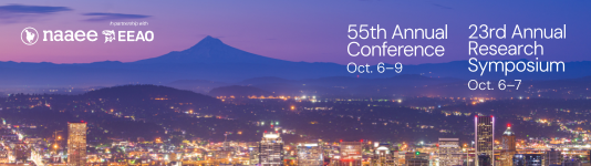 Portland at night with city illuminated and mountain against a purple sky.