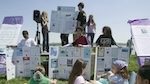 Students sit outside for an environmental education lesson