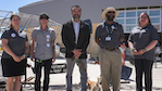 Vanessa Barela, Therese Baca-Radler, Dr. Arsenio Romero (NMPED Secretary of Education), Shafiq Chaudhary, and Patricia Gharrity stand in front of a sculpture at Earth Day Festival in New Mexico